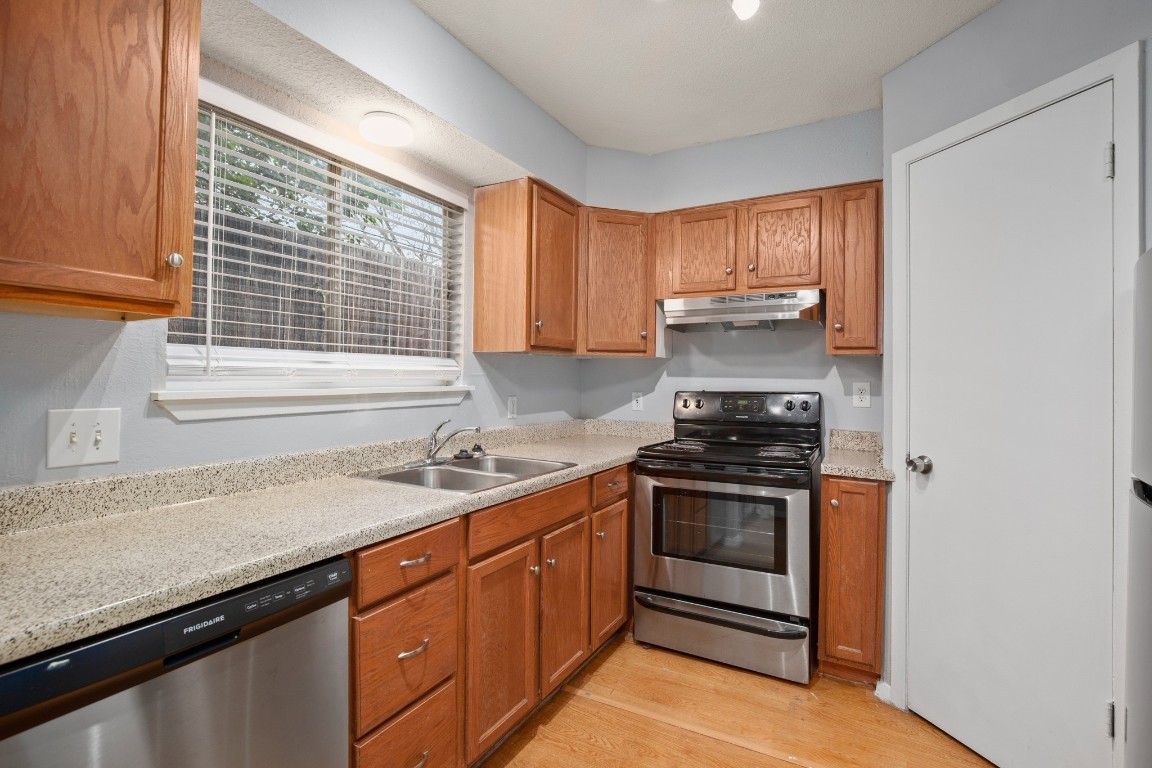 3415 Menchaca Road, Unit 101 Austin, TX 78704 - Photo 7 of 14 a kitchen with a sink stove and cabinets