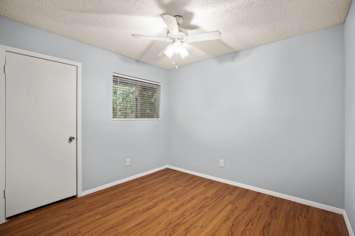 3415 Menchaca Road, Unit 101 Austin, TX 78704 - Photo 9 of 14 wooden floor in an empty room with a window