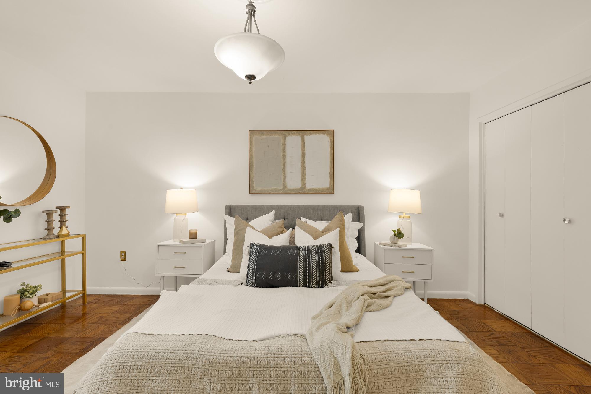 2400 41st Street Northwest, Unit 212 Washington, DC 20007 - Photo 15 of 24 a bedroom with a bed and a chandelier