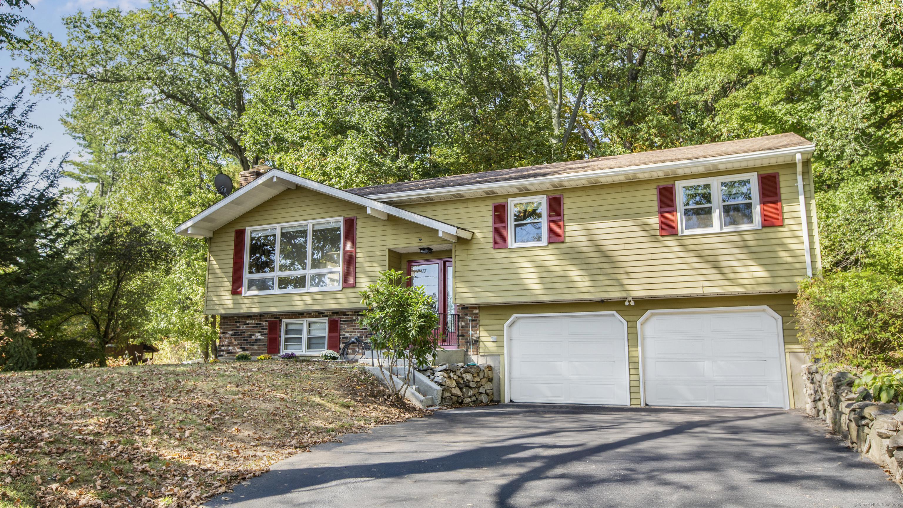 739 Field Street Naugatuck, CT 06770 - Photo 2 of 14 a front view of a house with a yard and garage