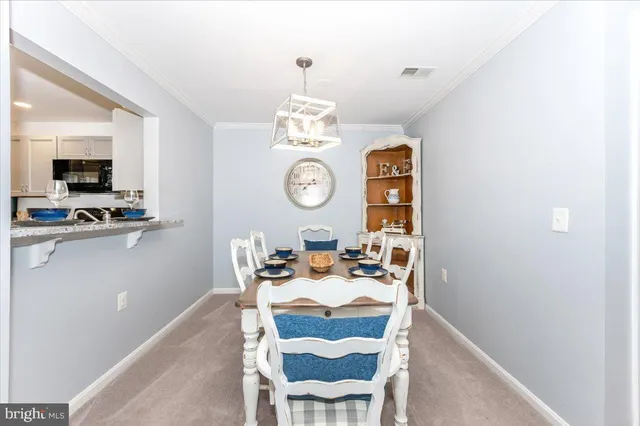a view of a dining room with furniture and chandelier