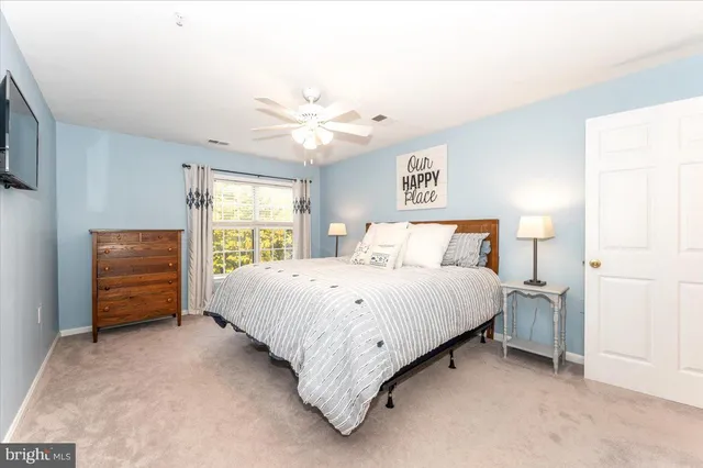 a spacious bedroom with a bed and a window