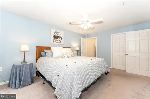 a bedroom with bed and a night stand