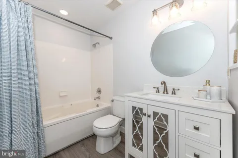 a bathroom with a toilet sink and a mirror