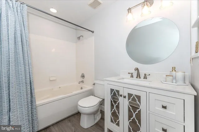 a bathroom with a toilet sink and a mirror