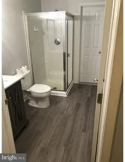 a bathroom with a toilet and a shower