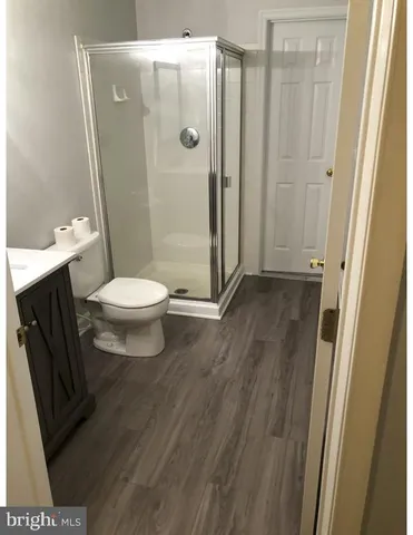 a bathroom with a toilet and a shower