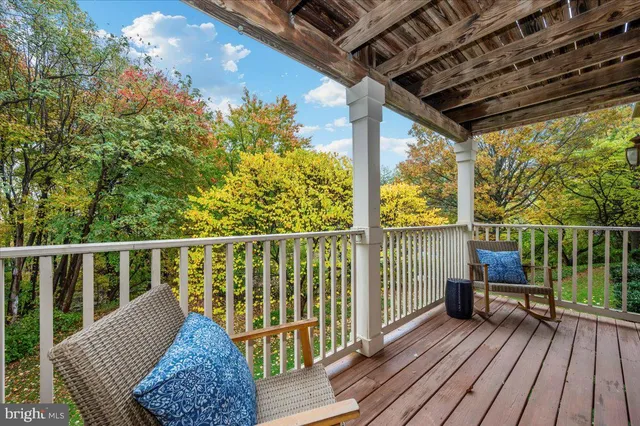 a view of balcony with wooden floor and fence