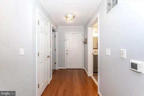 a view of a hallway with wooden floor