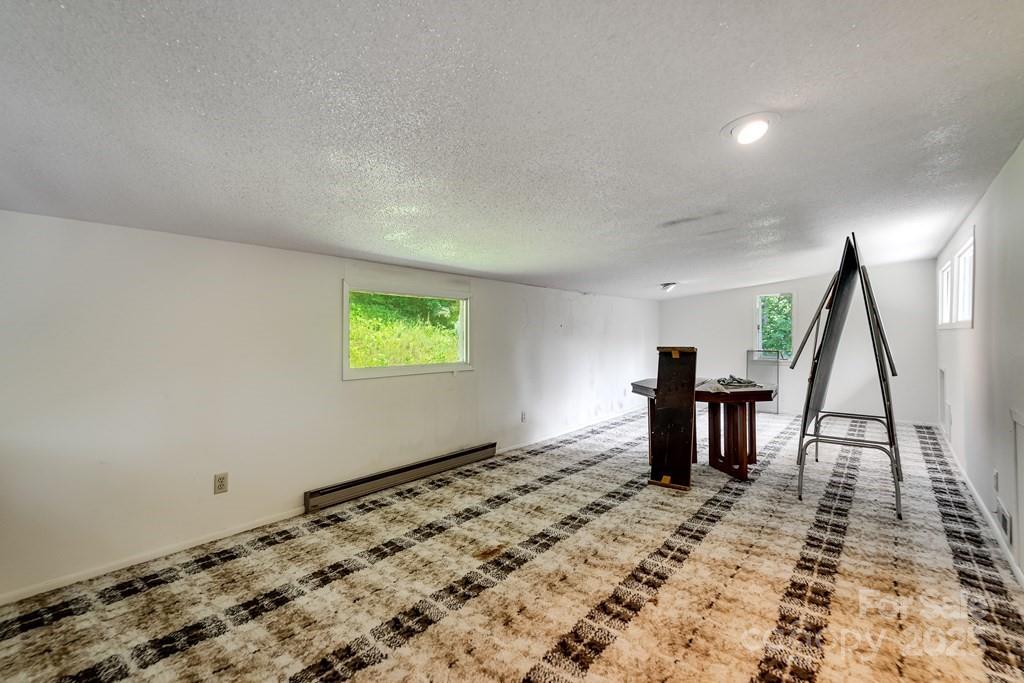 1040 Kitchens Branch Road Sylva, NC 28779 - Photo 24 of 48 a view of a room with a bench