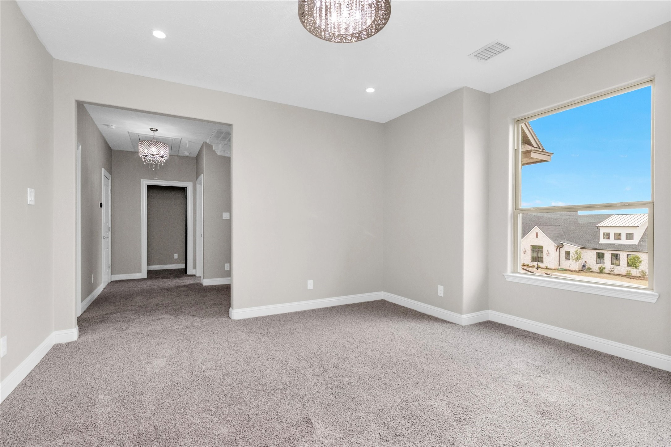 10887 Decatur Street Willis, TX 77318 - Photo 33 of 50 The landing at the top of the stairs gives an excellent space for a gameroom, playroom or quiet seating area with a large portrait window with views outside.