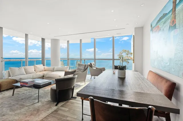 a living room with furniture and a floor to ceiling window