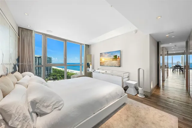 a bedroom with a large bed and a large window