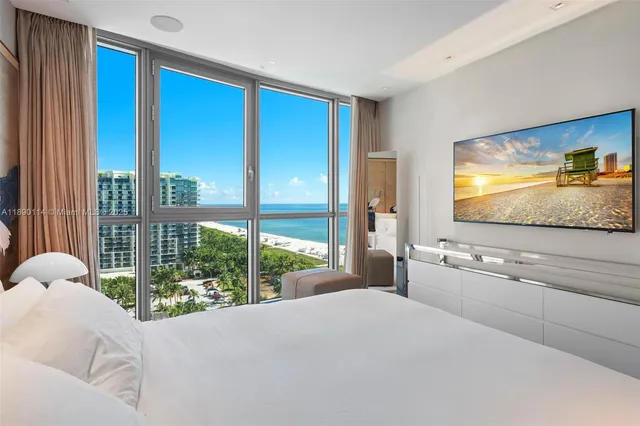 a living room with a large window and a flat screen tv