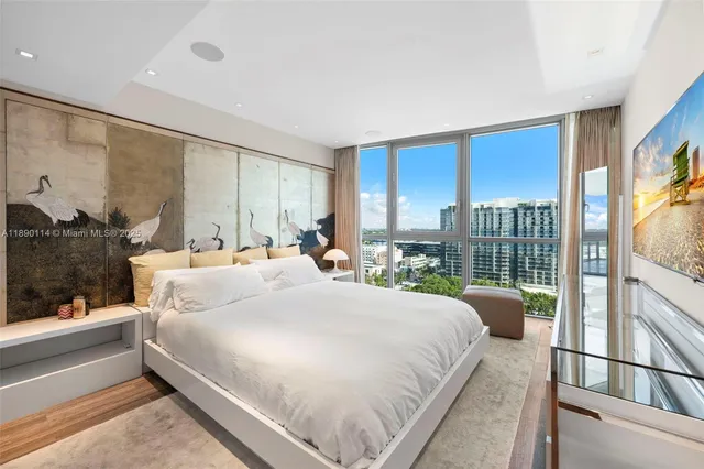 a bedroom with a large bed and a large window