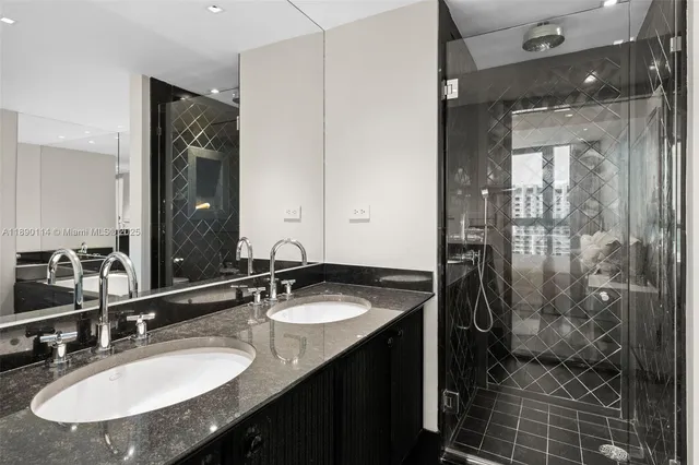 a bathroom with a sink double vanity and shower