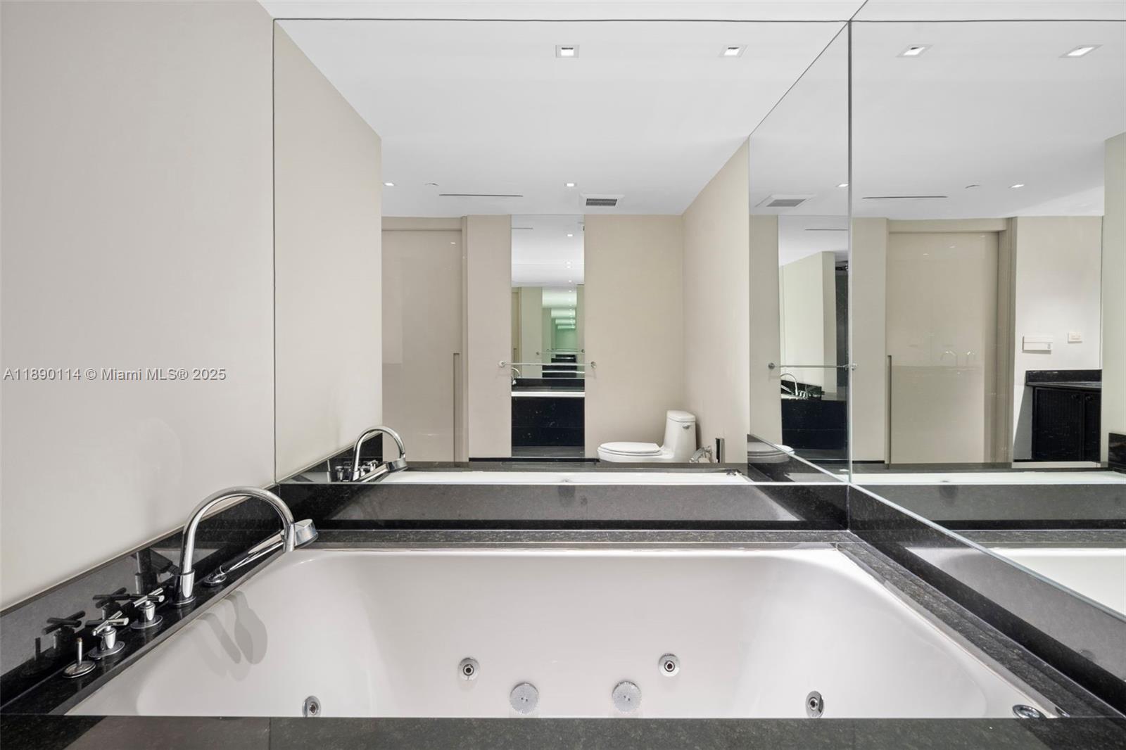 101 20th Street, Unit 2007 Miami Beach, FL 33139 - Photo 27 of 41 a room with a large bed and mirror