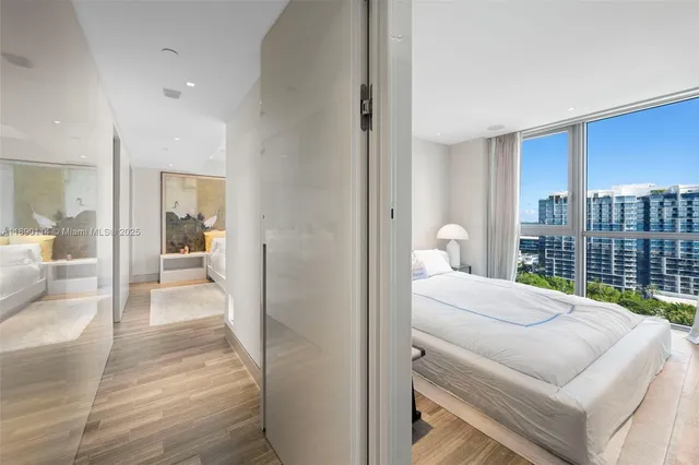 a bedroom with a bed and a large window