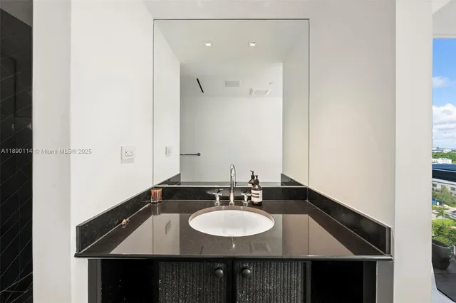 a bathroom with a sink and a mirror