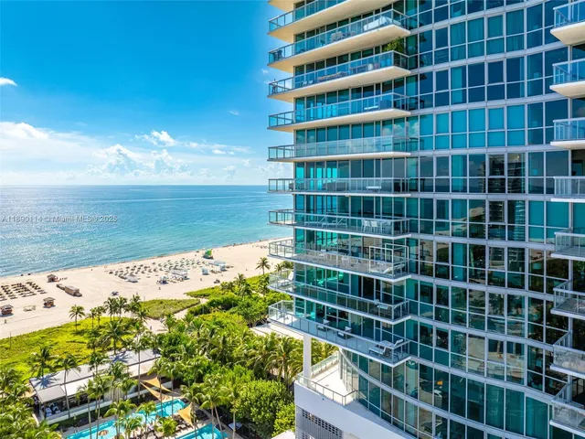 an aerial view of a residential apartment building with a yard and plants