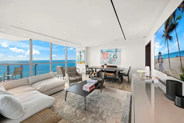 a living room with furniture large window and flat screen tv