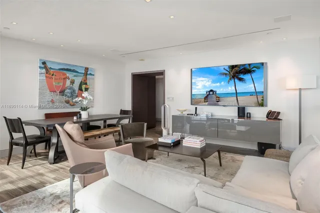 a living room with furniture and a painting on the wall