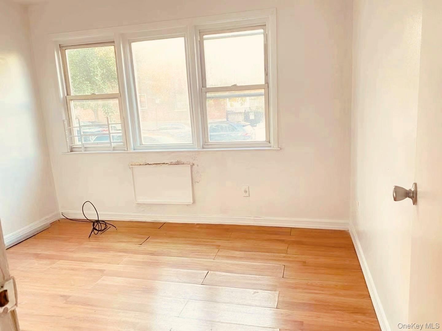 41-08 111th Street Queens, NY 11368 - Photo 5 of 9 a view of a room with wooden floor and a window