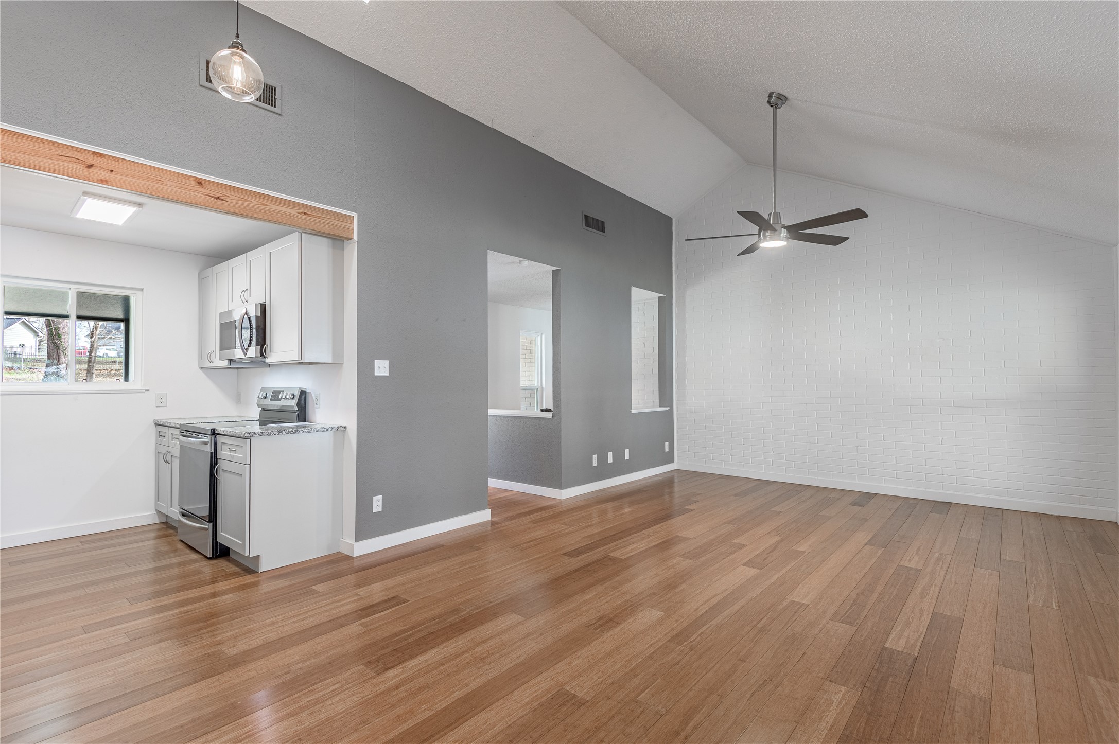 356 Peach Island Road Trinity, TX 75862 - Photo 12 of 34 wooden floor in an empty room with a window