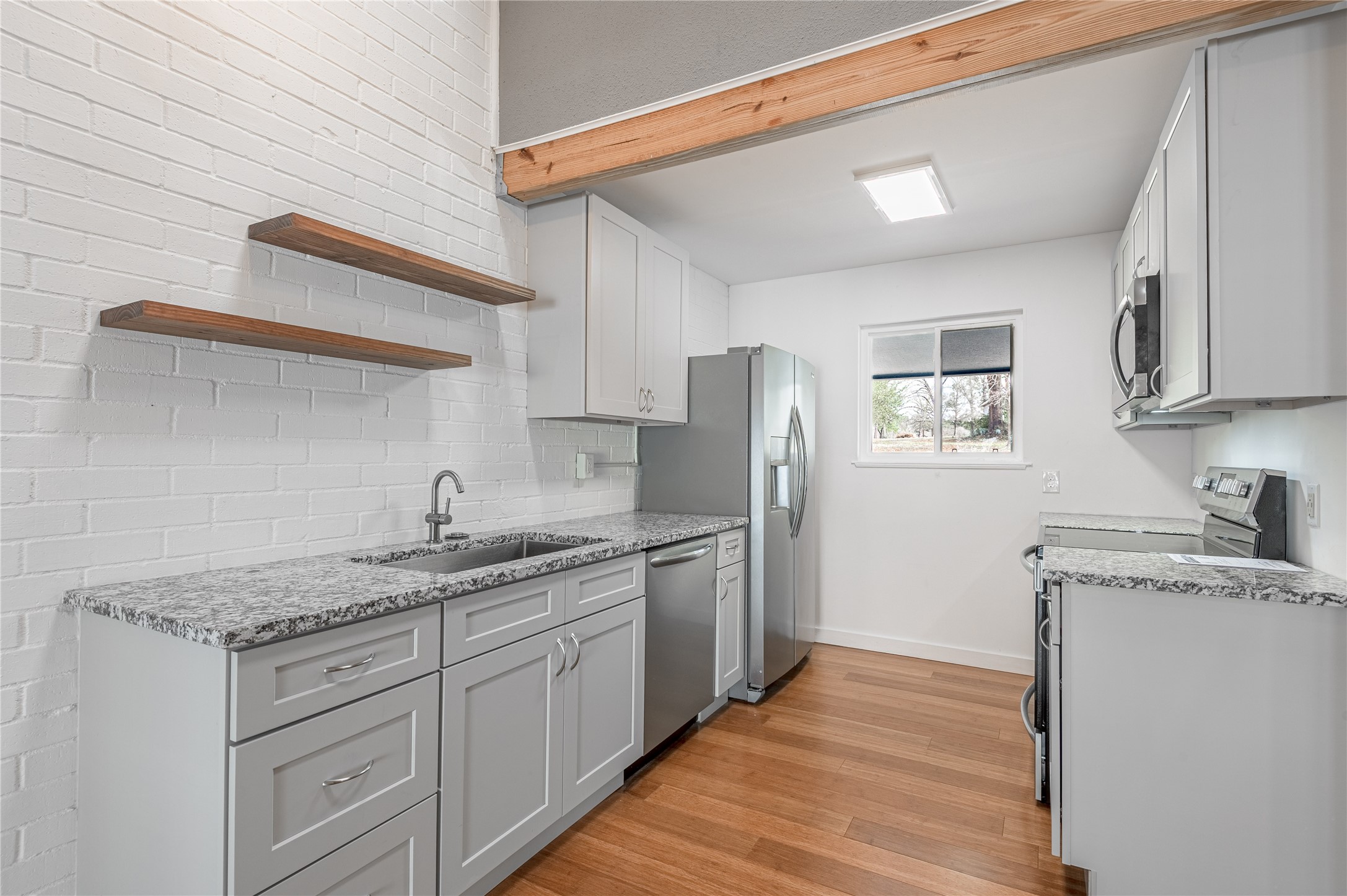 356 Peach Island Road Trinity, TX 75862 - Photo 13 of 34 a kitchen with stainless steel appliances granite countertop a sink stove and refrigerator