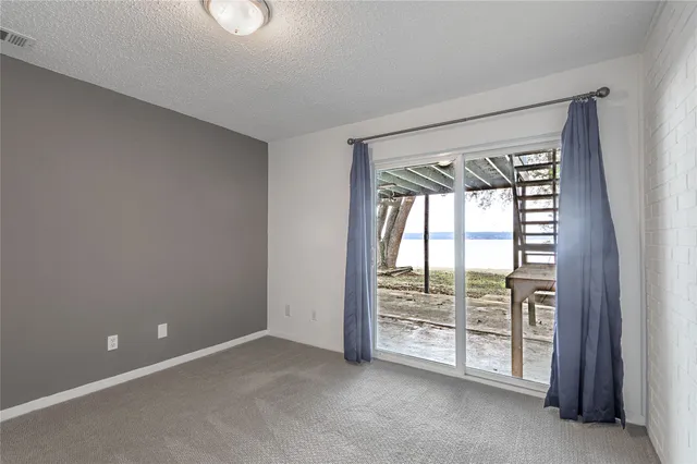 an empty room with windows and city view