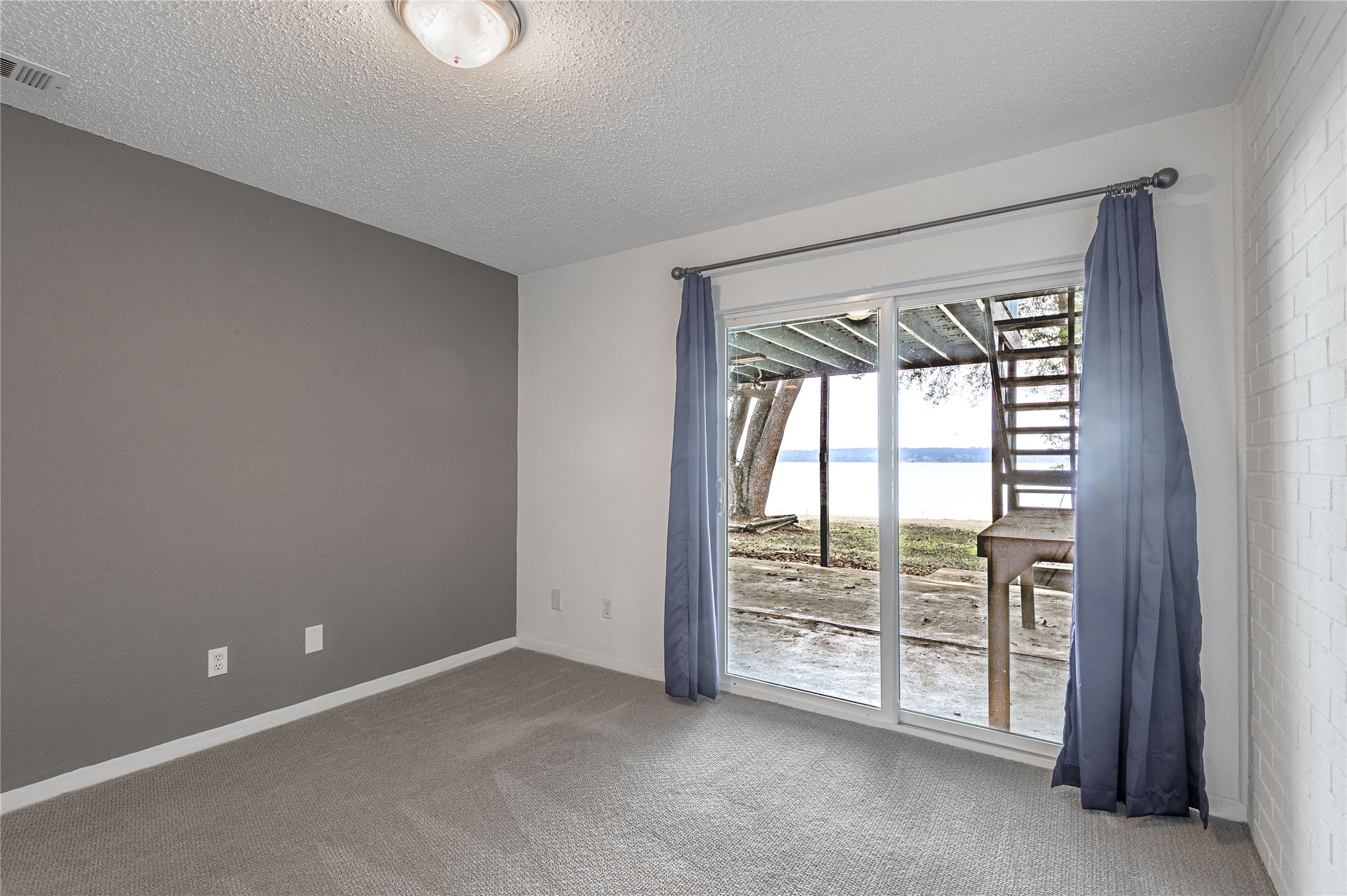 356 Peach Island Road Trinity, TX 75862 - Photo 24 of 34 an empty room with windows and city view