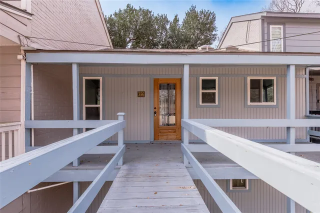a view of balcony with two large windows