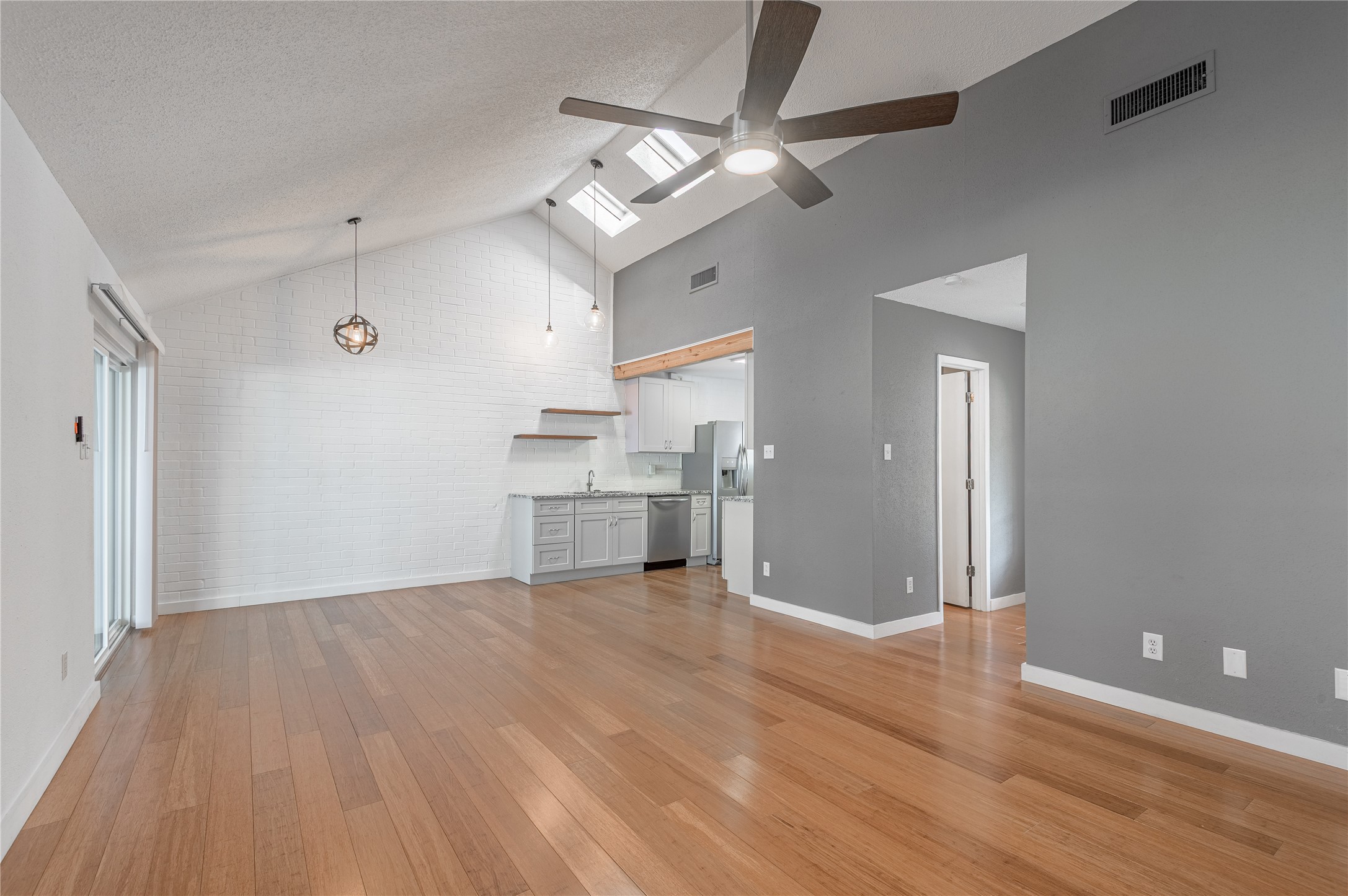356 Peach Island Road Trinity, TX 75862 - Photo 9 of 34 a view of a kitchen with wooden floor a sink and a refrigerator