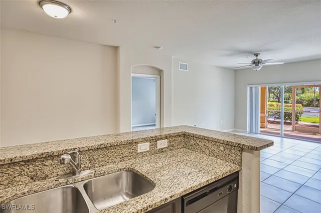 a view of a sink and dishwasher with wooden floor