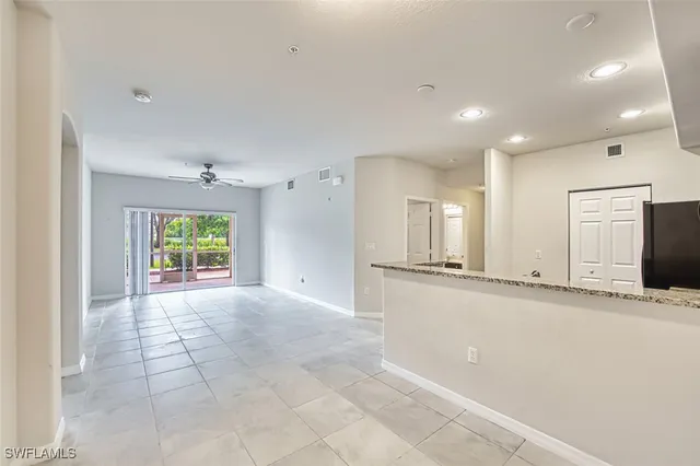 a large space with a large window and chandelier