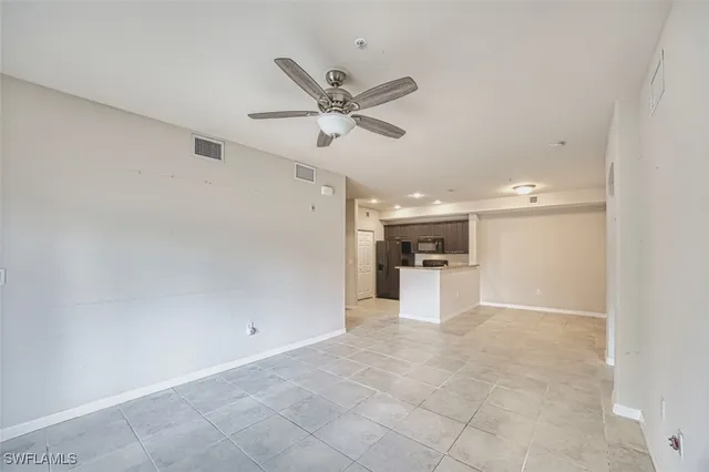 a view of a kitchen with a sink and a refrigerator