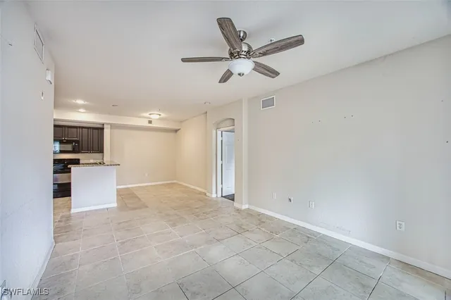 a view of a kitchen with a sink and a refrigerator