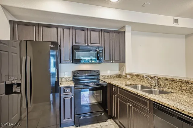 a kitchen with a sink stove and refrigerator
