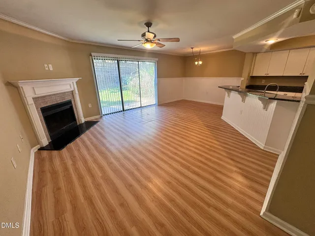 a open kitchen with cabinets stainless steel appliances and wooden floor