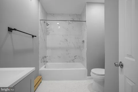 a bathroom with a bathtub and a toilet