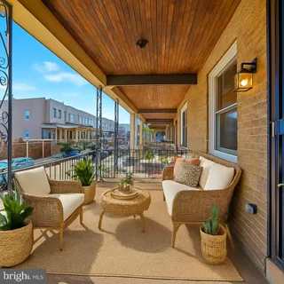 a balcony with furniture and an umbrella