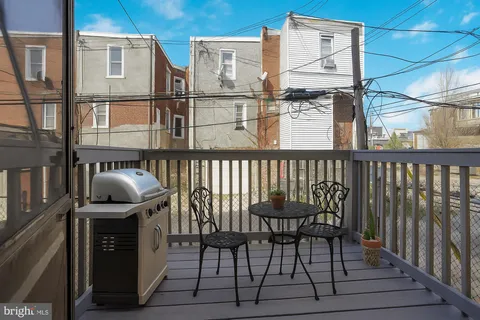 a view of a chair and table in the balcony