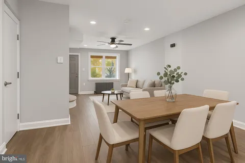 a view of a dining room with furniture and a potted plant