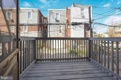 a view of a balcony with wooden floor