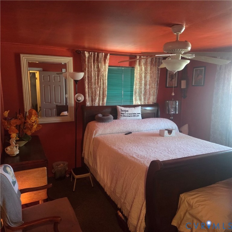 3065 Chickahominy Road Toano, VA 23168 - Photo 3 of 15 a bed sitting in a bedroom next to a window