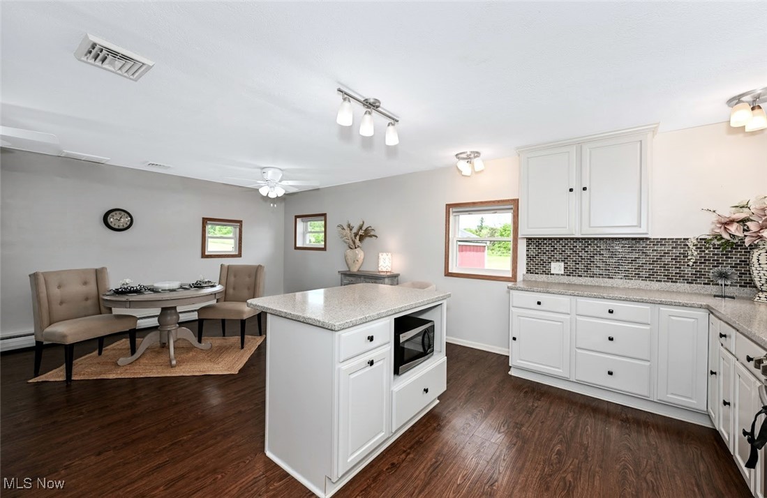 4597 Rock Cut Road Barberton, OH 44203 - Photo 18 of 44 *COMPLETELY REMODELED, EXTENDED KITCHEN W/WHITE CABINETS, SOFT CLOSE DRAWERS, PULL OUT DRAWERS, PANTRY, ISLAND WITH BREAKFAST BAR, MOSAIC TILE BACKSPLASH, TONS OF LIGHTING, STAINLESS STEEL APPLIANCES & LARGE DINING AREA ~