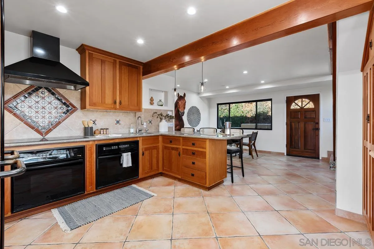 974 Via Hillview Fallbrook, CA 92028 - Photo 7 of 43 a kitchen with stainless steel appliances granite countertop a stove and a sink