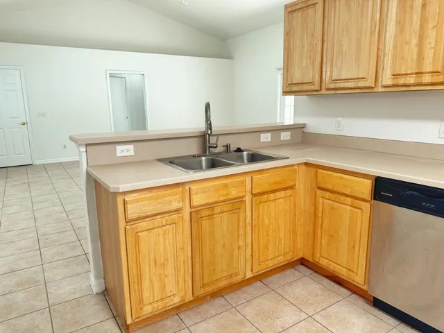 a kitchen with stainless steel appliances granite countertop a sink and cabinets