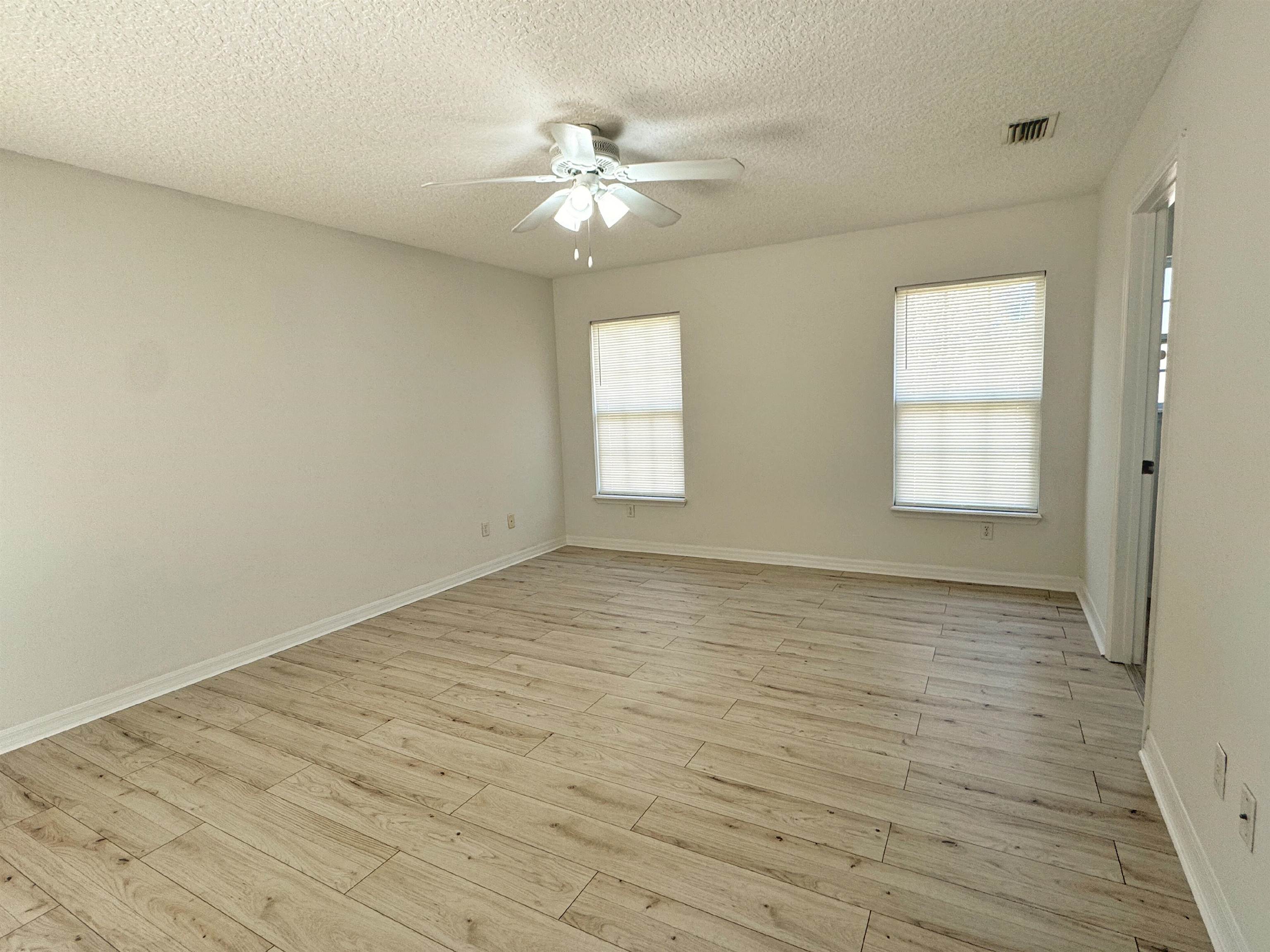 632 Segovia Road St. Augustine, FL 32086 - Photo 15 of 28 an empty room with wooden floor and windows