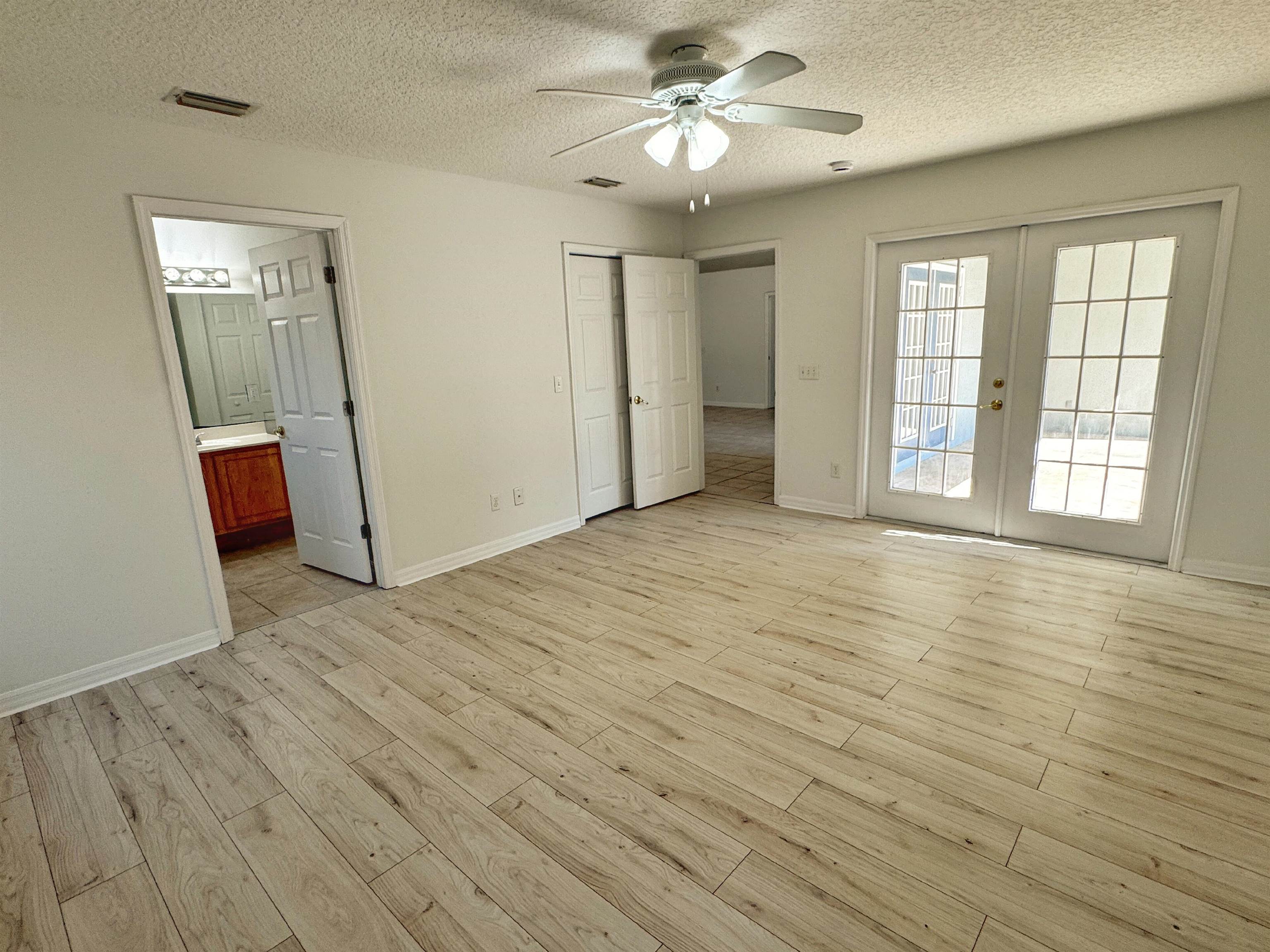 632 Segovia Road St. Augustine, FL 32086 - Photo 16 of 28 an empty room with wooden floor and windows
